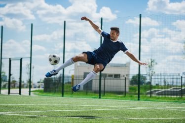 athletic-soccer-player-kicking-ball-on-soccer-pitch.jpg athletic-soccer-player-kicking-ball-on-soccer-pitch.jpg