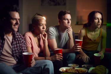 group-of-friends-with-drinks-sitting-on-sofa-at-home-watching-horror-movie-together.jpg group-of-friends-with-drinks-sitting-on-sofa-at-home-watching-horror-movie-together.jpg